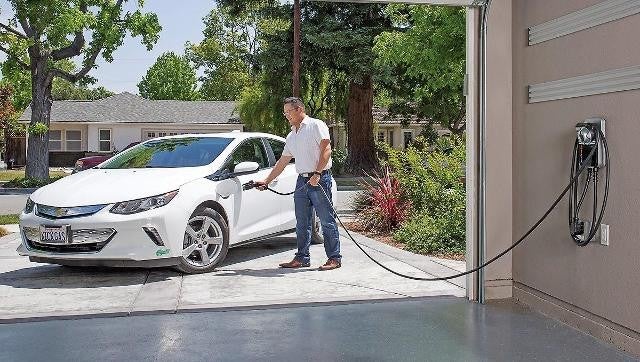 A person cgarging his ev at home